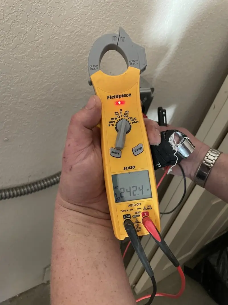 Voltage testing with clamp meter during Recessed Lighting Installation in Gilbert